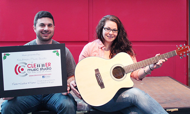 Montco Radio Station Managers David Tatasciore and Chelsea Epstein with the raffle guitar. Photo by Alana J. Mauger